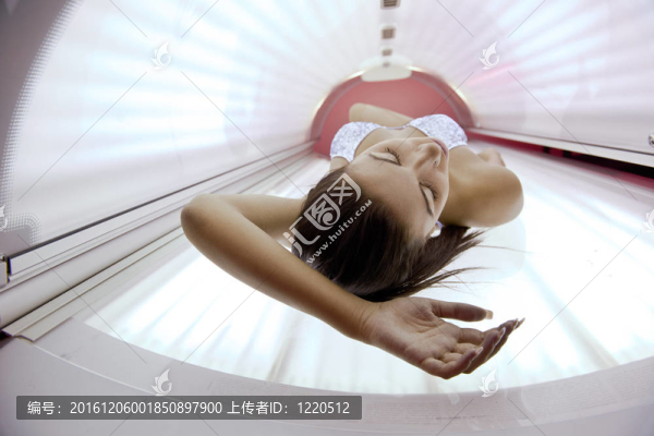 美麗的年輕女子曬日光浴