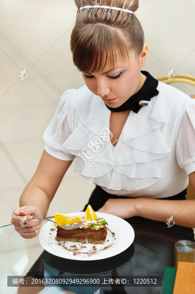 女人坐著吃蛋糕