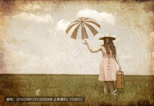 黑發(fā)女巫在春田的傘和行李箱。