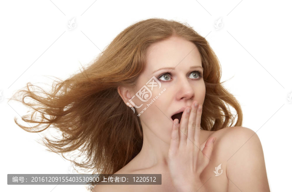 美麗令人驚訝的女孩與流動的頭發(fā)覆蓋張開的嘴與她的手在震驚孤立的白色背景