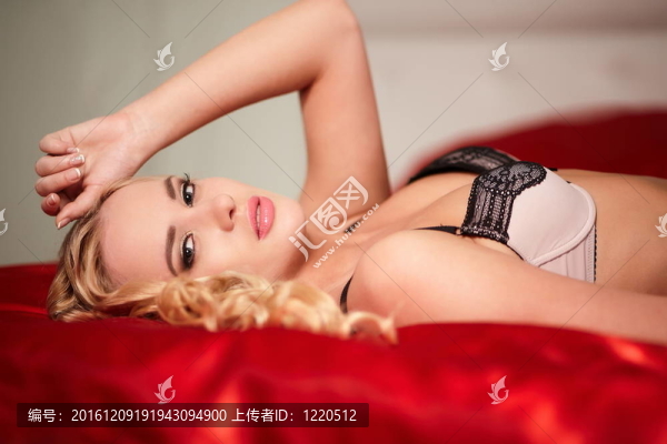 美麗的性感女孩躺在床上的內(nèi)衣與明亮的化妝和發(fā)型