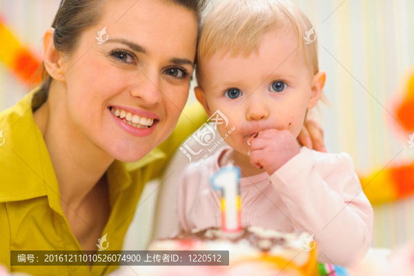 母親和孩子吃生日蛋糕的肖像