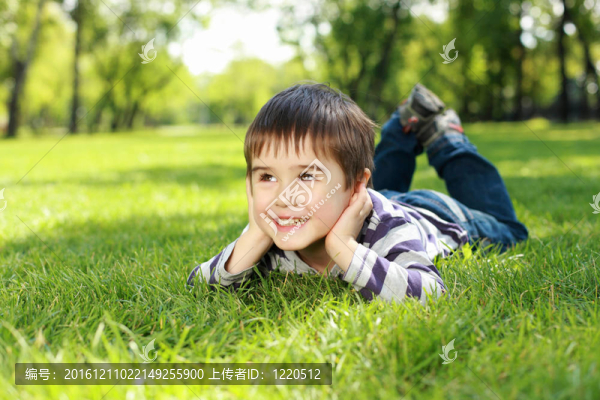 一個(gè)男孩在公園里拿著一本書(shū)的肖像