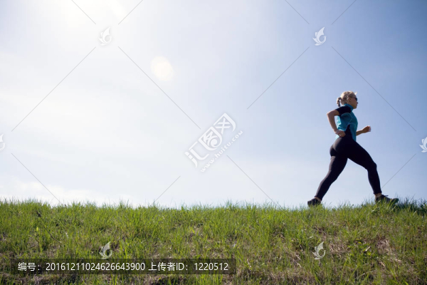 在綠色小徑上奔跑的年輕女子