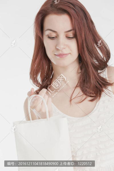 年輕女子拿著白色購物袋