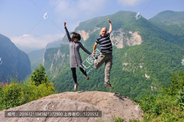 快樂的年輕情侶在空中跳躍