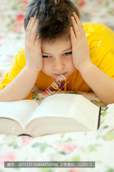 一個(gè)男孩在床上看書