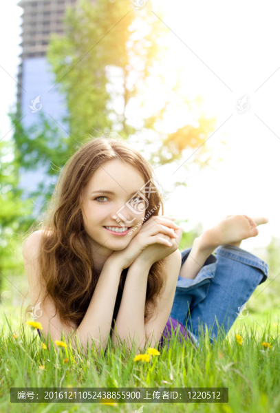 年輕的黑發(fā)少女微笑在草甸