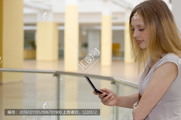 購物中心的年輕女人帶手機