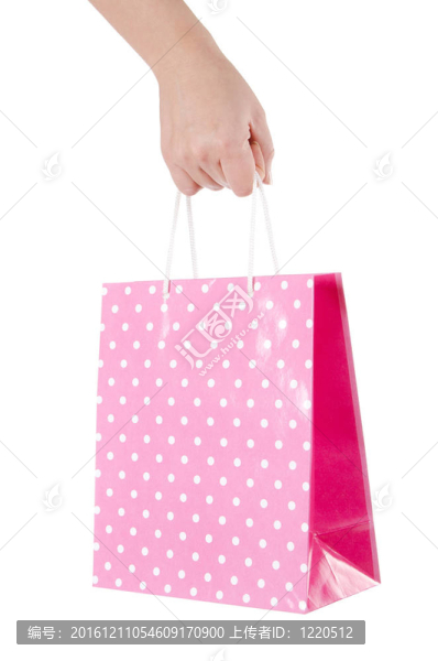 明亮的禮品袋在白色的手孤立