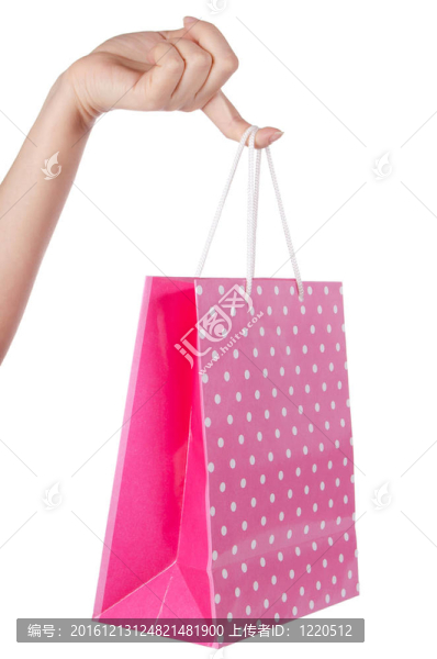 明亮的禮品袋在白色的手孤立