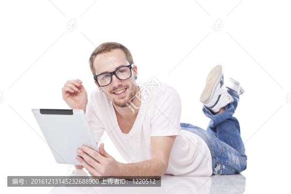 隨著平板電腦躺在地板上的書(shū)呆子的人聰明