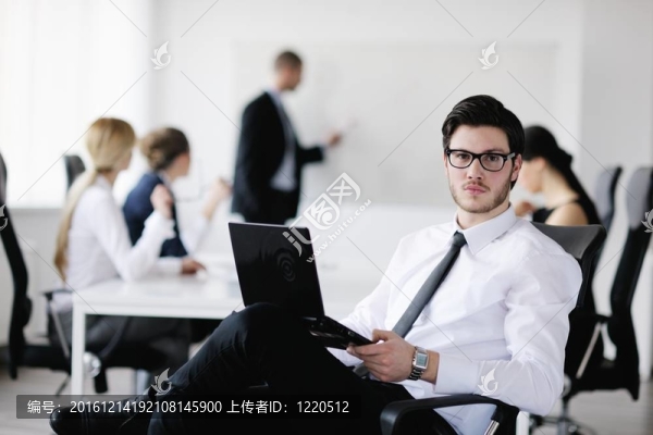 一個英俊的年輕商人與同事背景的肖像