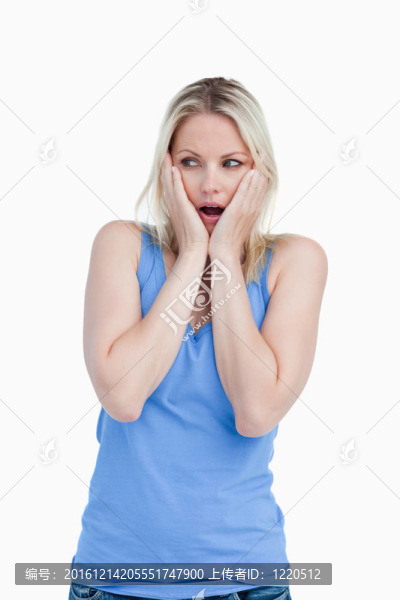 驚訝的金發(fā)女人把手放在臉頰上