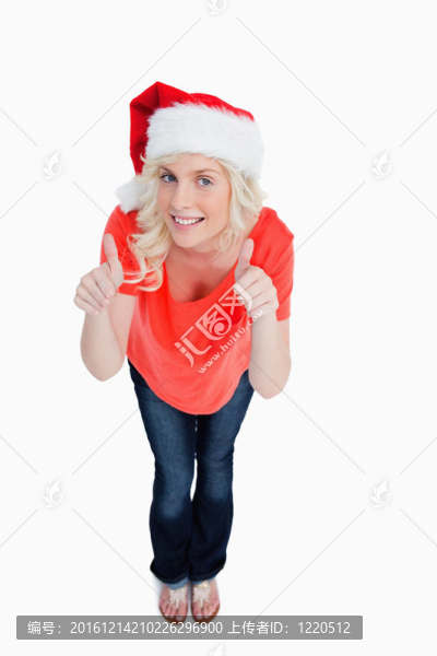 金發(fā)女郎在穿著圣誕衣服時豎起大拇指表示滿意