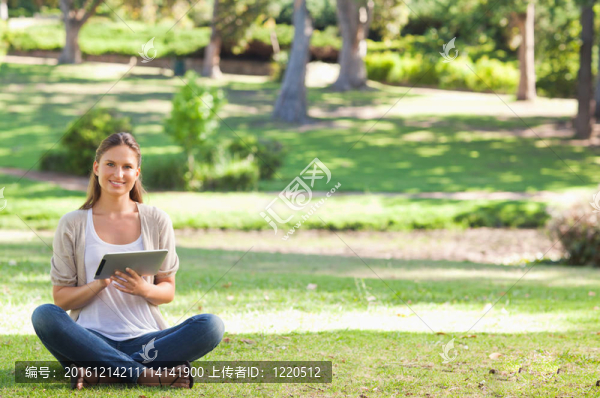 在公園里的女人用她的平板電腦