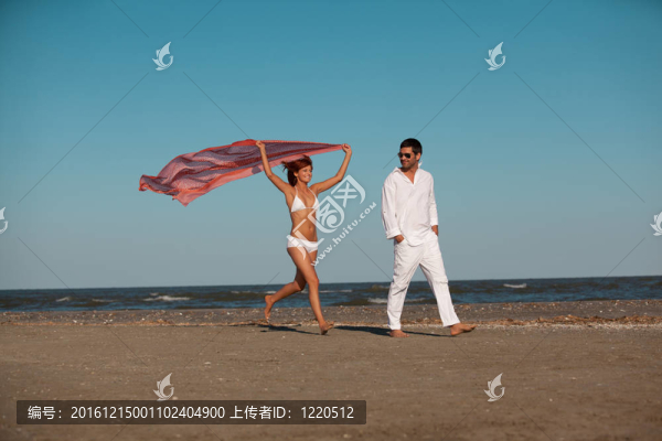 快樂的；年輕的夫婦沿著海岸