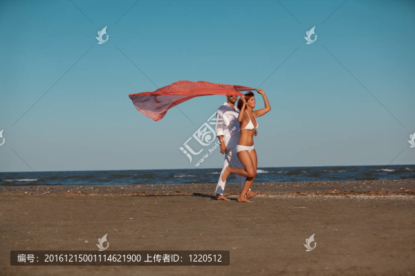 快樂的；年輕的夫婦沿著海岸
