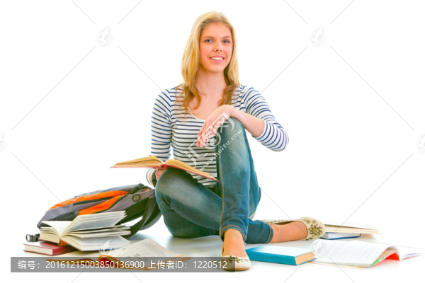 開朗的女孩坐在地上在教科書