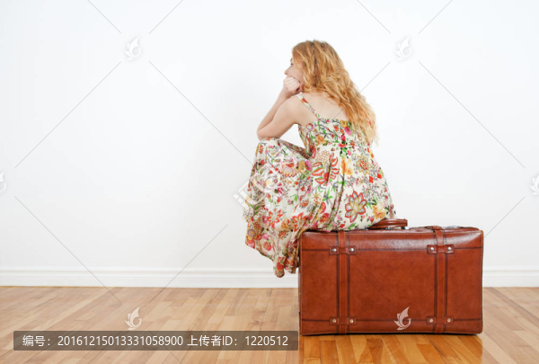 女孩坐在老式手提箱期待旅行