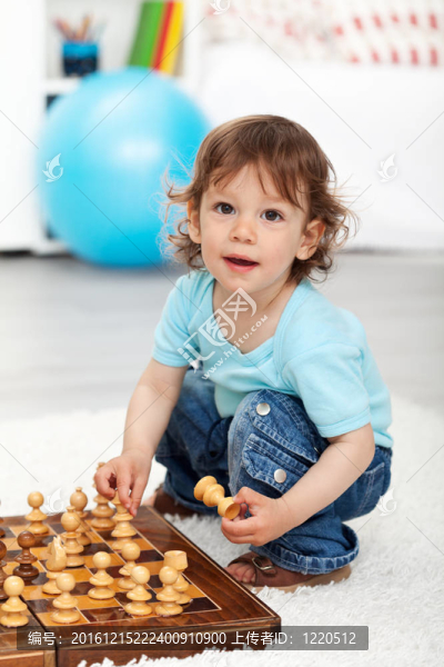 可愛的小男孩玩棋子