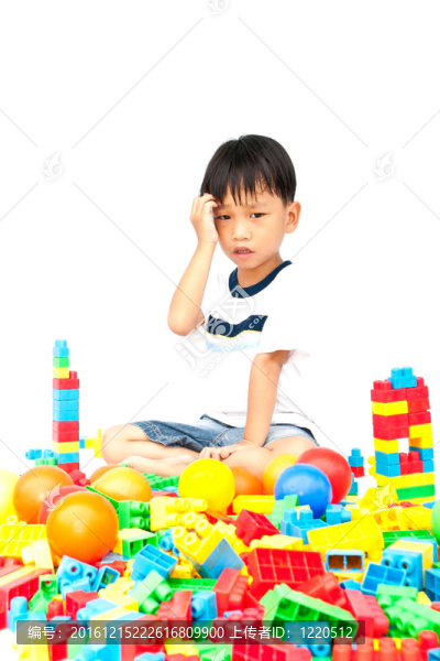 在白色背景上玩玩具的小男孩