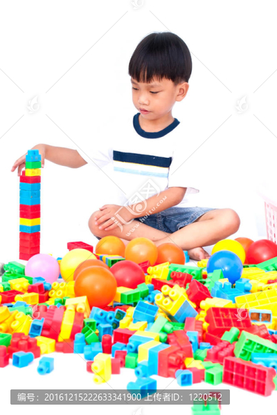 在白色背景上玩玩具的小男孩