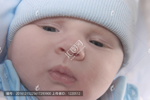 漂亮的孩子戴著藍(lán)色的帽子，若有所思