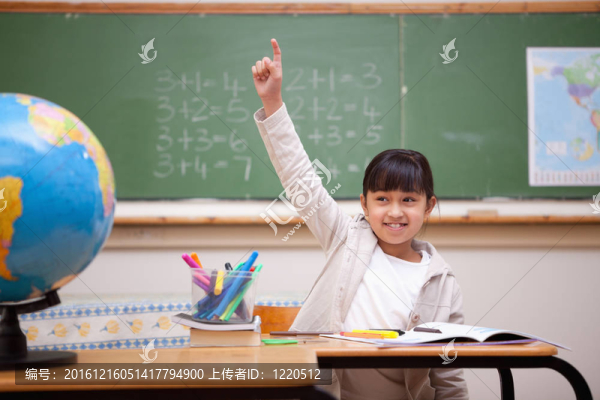 微笑的女學(xué)生舉手回答問(wèn)題