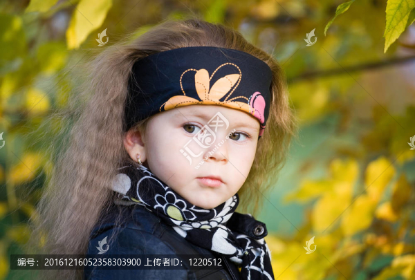 在一個黑色的皮夾克和頭巾的小女孩