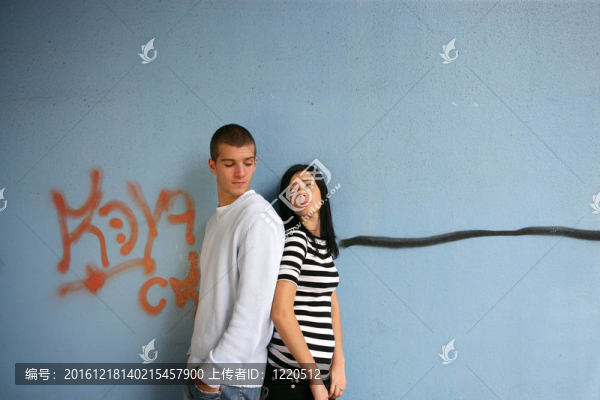 年輕夫婦站在涂鴉墻前