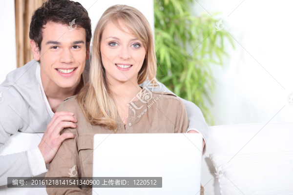 年輕夫婦在室內(nèi)使用筆記本電腦
