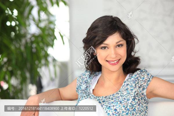 女人在一個華麗的頂部坐在沙發(fā)上