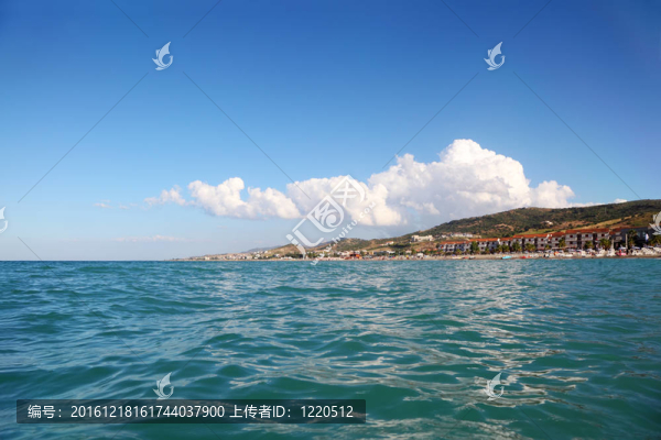 海藍(lán)色的水；遠(yuǎn)處的山和建筑的療養(yǎng)院海灘；