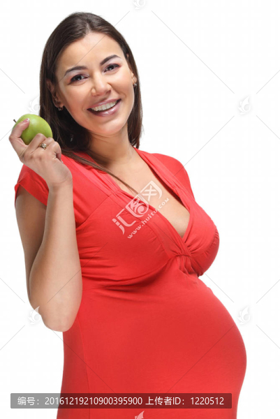 懷著綠色蘋果的快樂孕婦