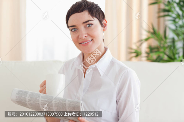 一杯和報(bào)紙的黑發(fā)女人肖像