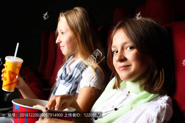 兩個年輕女孩在電影院看電影