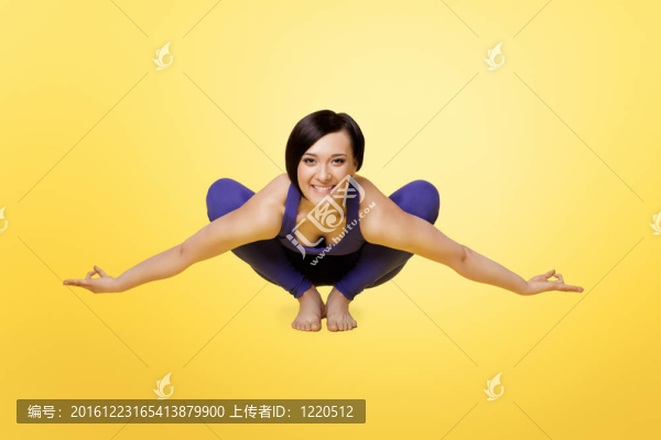 女人練習(xí)瑜伽手臂平衡和微笑