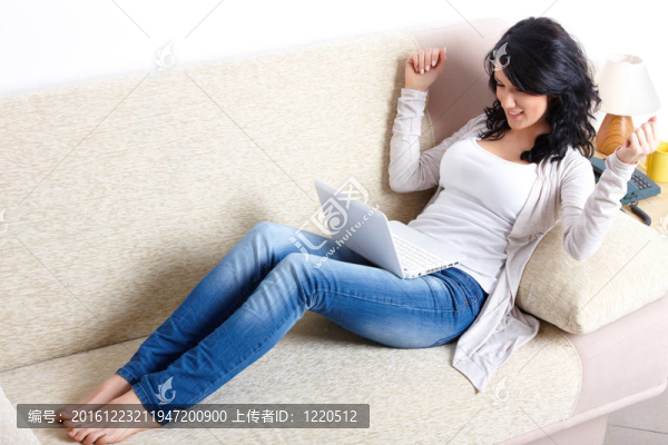美麗的女人與上網(wǎng)本躺在沙發(fā)上