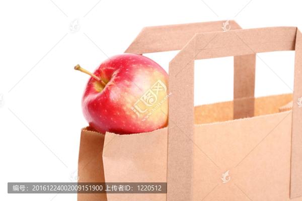 購物棕色禮品袋和蘋果隔離