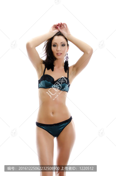 美麗的年輕女子穿著綠色內衣。白色隔離。