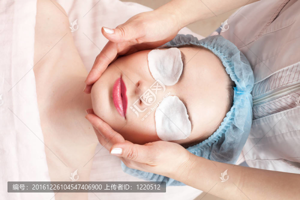 美麗肌膚的女人得到美容治療-按摩她的臉在沙龍