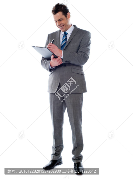 成功的商人在剪貼板上寫筆記
