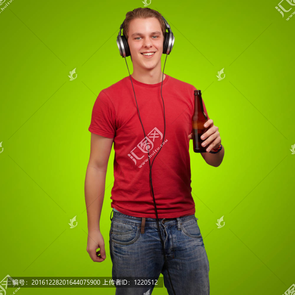 年輕人在綠色背景下聆聽音樂和手持啤酒的肖像