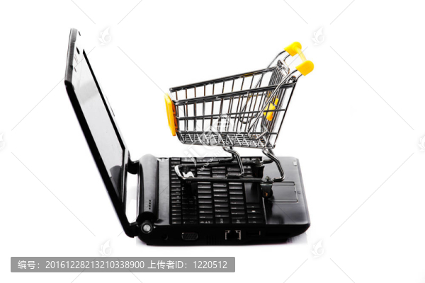 網(wǎng)上購(gòu)物。白色筆記本電腦購(gòu)物車。