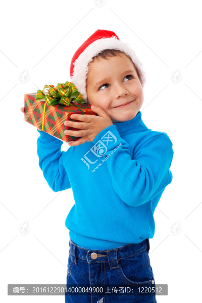 微笑的男孩在Santa的帽子與禮品盒