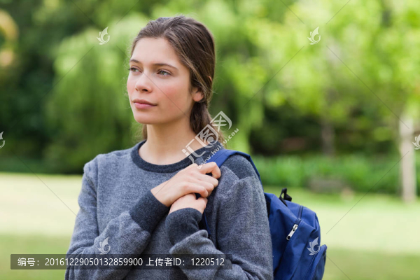 年輕輕松的女孩一邊看著一邊站在公園里