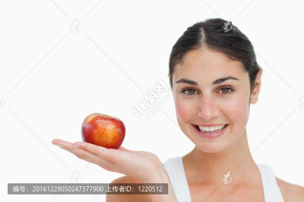 女人在節(jié)食，手里拿著一個(gè)蘋(píng)果