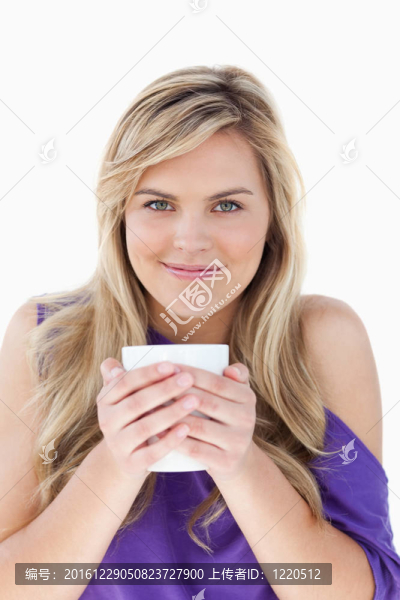 年輕的金發(fā)女人拿著一杯咖啡