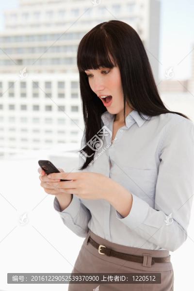 震驚的女人在手機上讀了一段文字